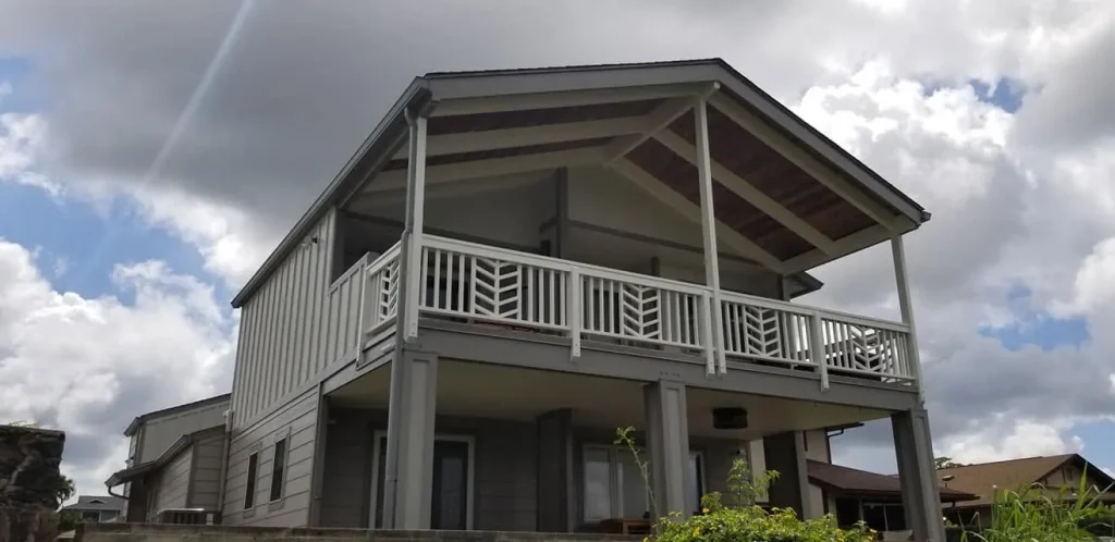 Two-story home with covered upper lanai and patterned railing